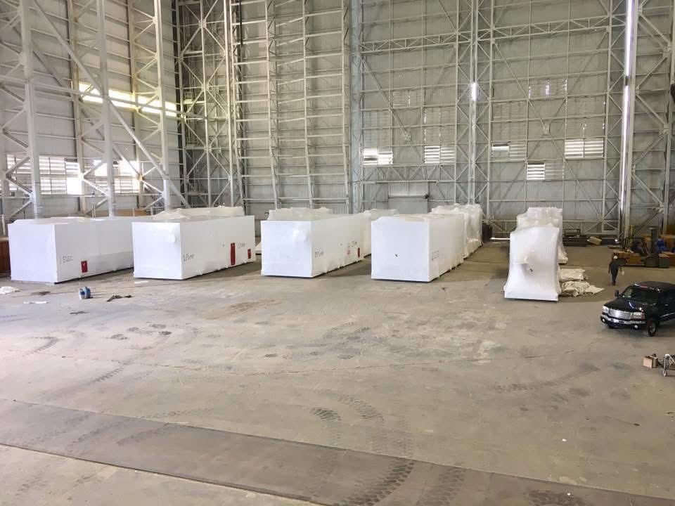 Shrink wrapped industrial equipment inside warehouse