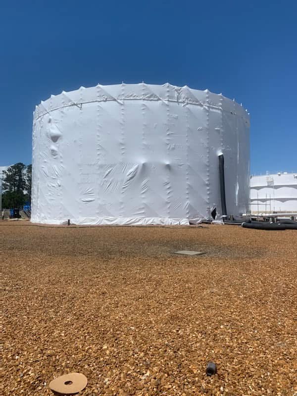 Large storage tank protected with industrial shrink wrap