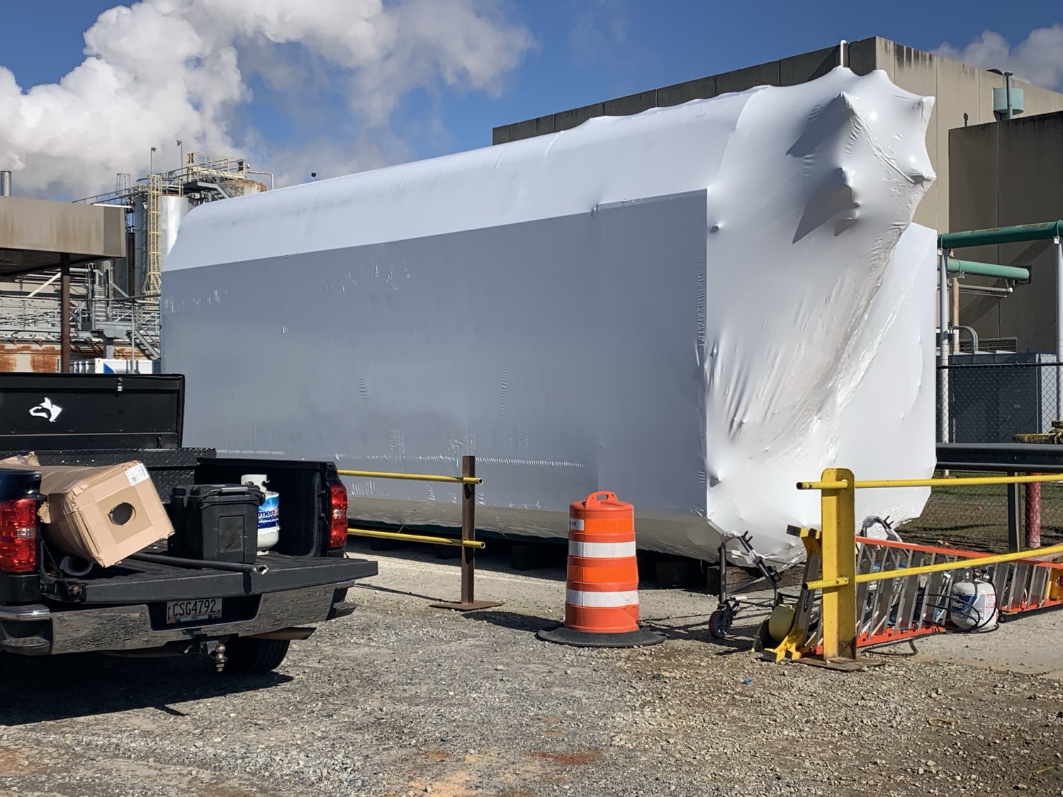 Large industrial equipment shrink wrapped on site