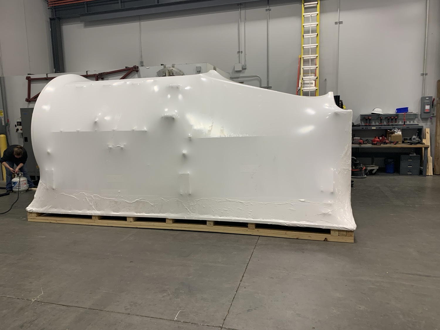 Machinery being shrink wrapped in shop