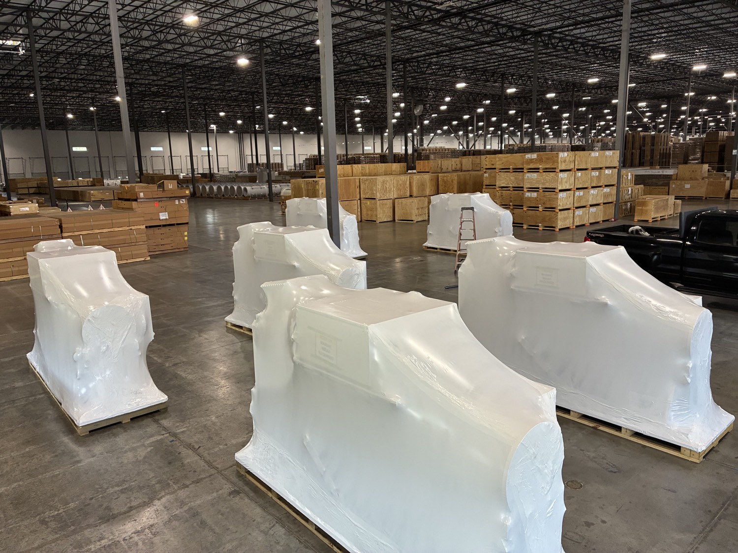 Multiple large components wrapped in warehouse